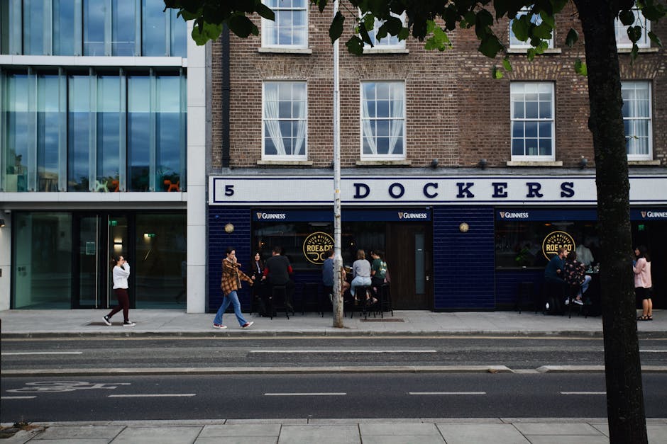 A vibrant street view in Dublin showing a bar, diverse people, and urban architecture.