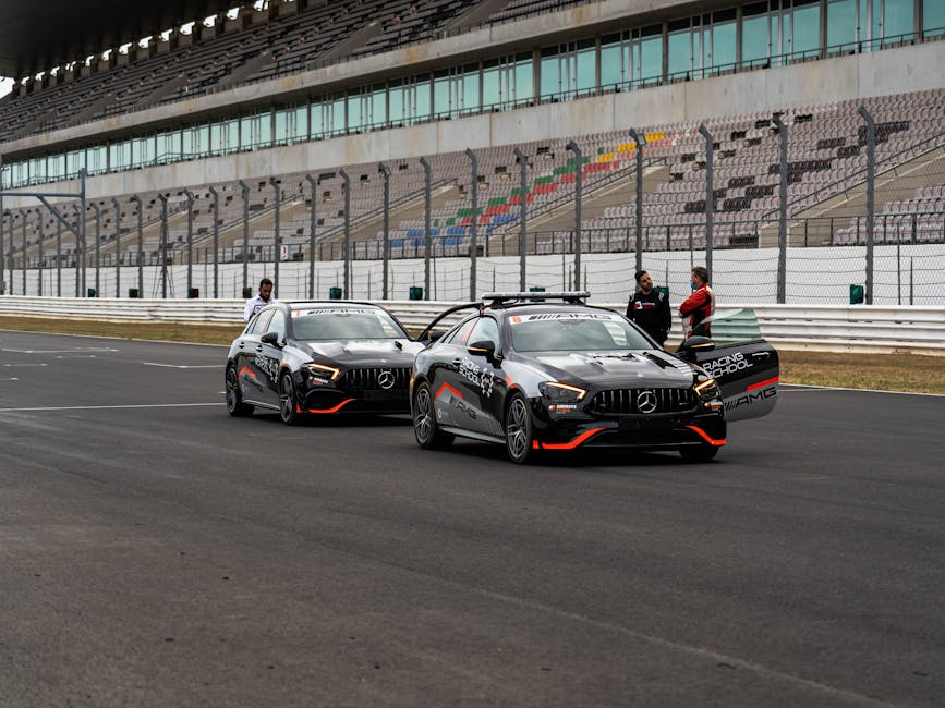 Two Mercedes AMG cars on the Portimão race track, showcasing luxury and performance.