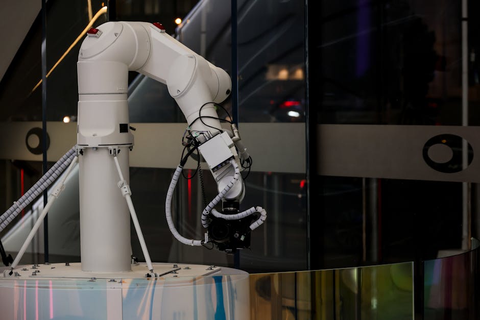 A white robotic arm operating indoors with a modern design and advanced technology.