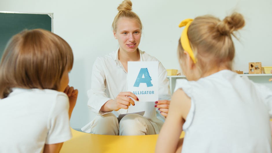 A teacher showing alligator-themed alphabet cards to young students in a classroom setting.