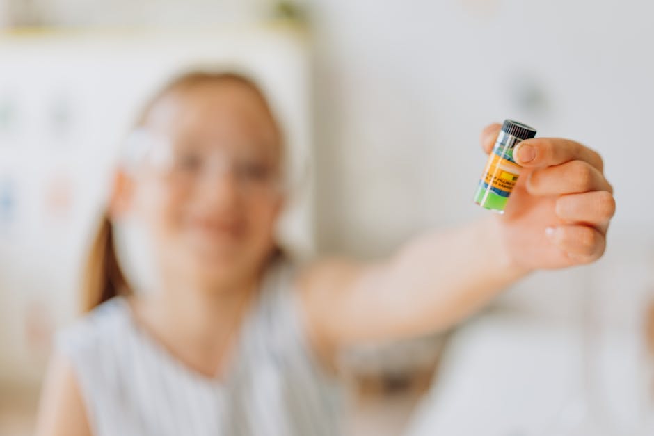 A smiling girl holds a colorful vial, exploring a science experiment in a playful setting.