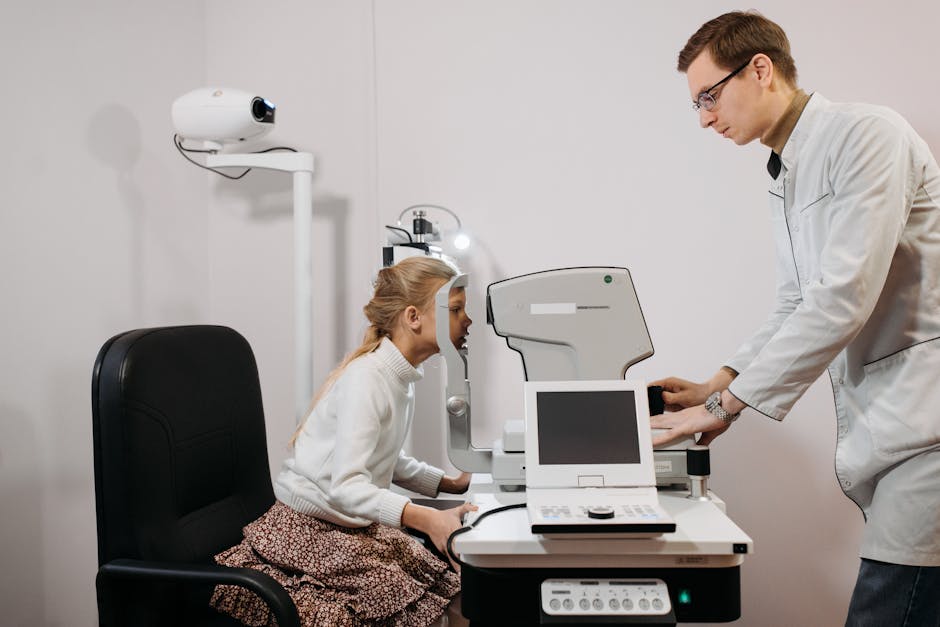 A young girl receives an eye exam from an optician in a clinical setting, focused on vision health.