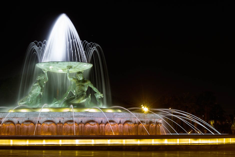 Long exposure of Triton Fountain in Valletta, Malta, illuminated against the night sky.