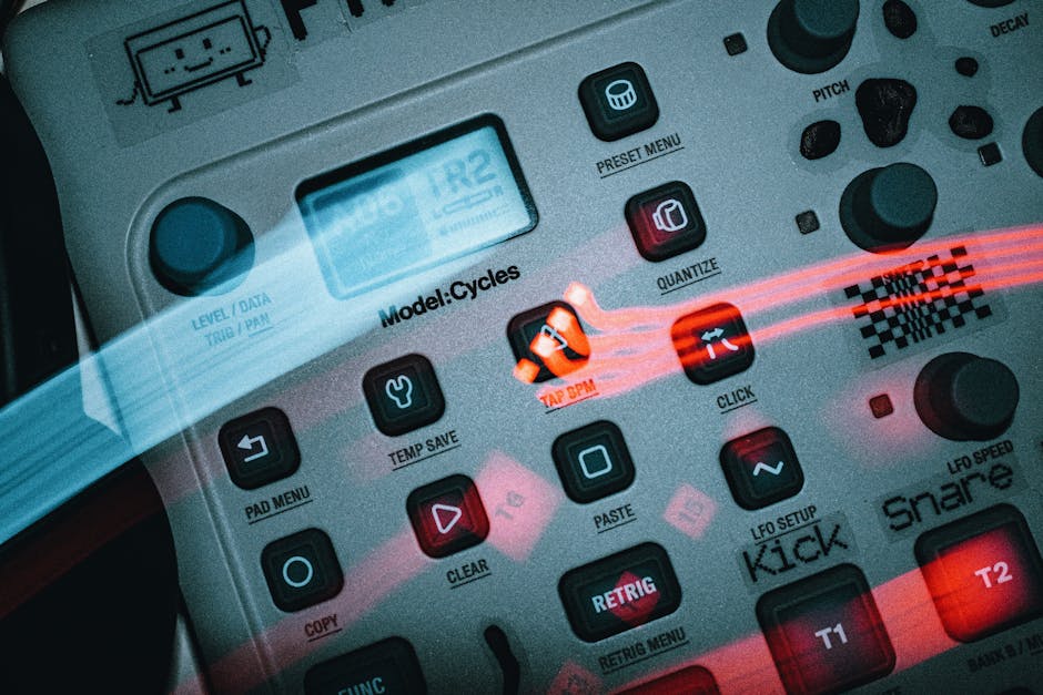 Detailed view of an electronic music sequencer with buttons and dials, showcasing a sleek design.