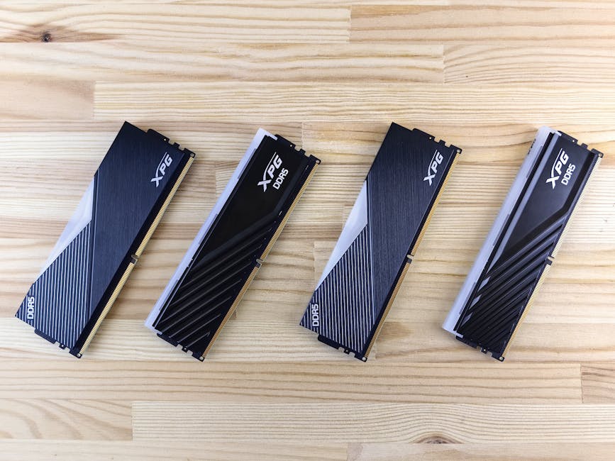 Four XPG DDR5 RAM modules aligned on a wooden surface, showcasing modern computing technology.