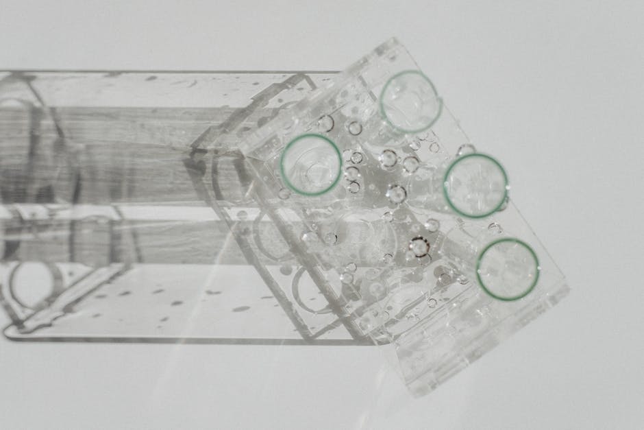 Laboratory glassware setup viewed from above on a white background, featuring various flasks.