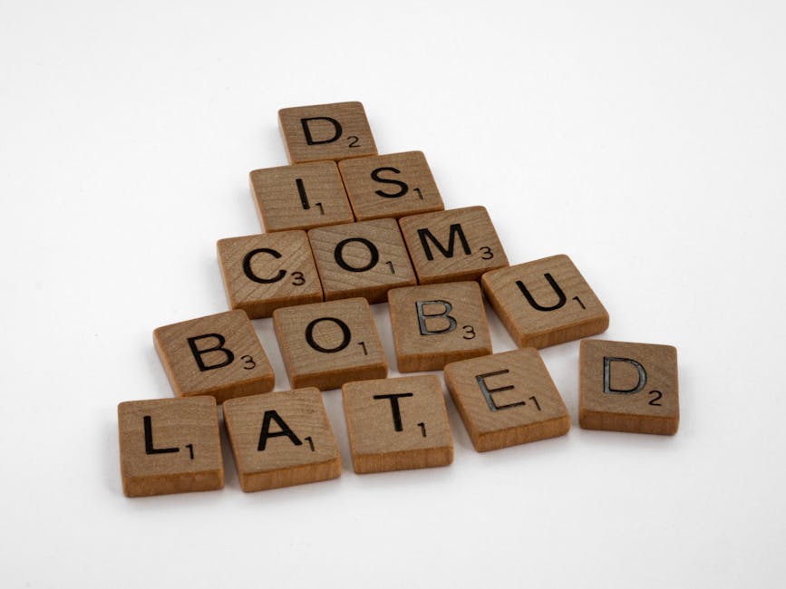 Scrabble tiles arranged to spell 'discombobulated' on a clean white surface, ideal for concept art.