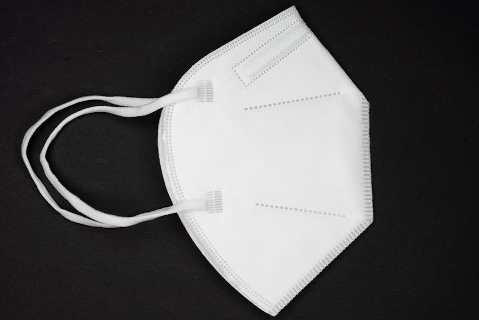 A white KN95 face mask against a black background emphasizing health protection.