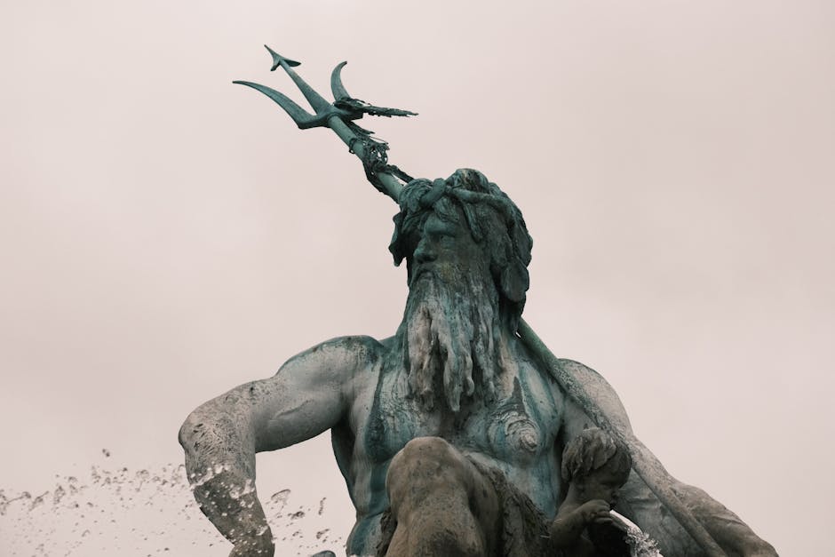Majestic close-up of Neptune statue at the Neptune Fountain, Berlin, showcasing intricate details of mythological art.