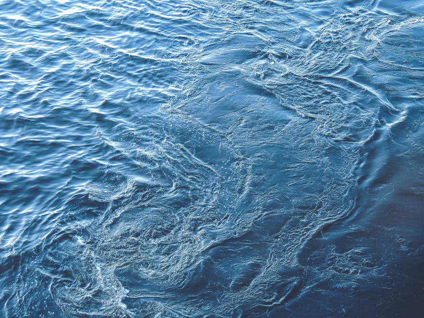 Close-up of clear blue water with ripples, showcasing texture and motion.
