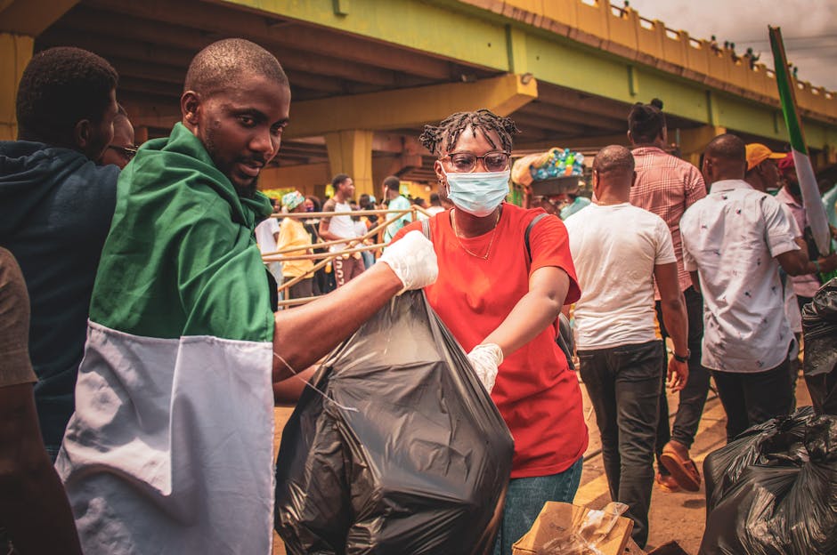 Group participating in community cleanup under an urban bridge, promoting environmental conservation.