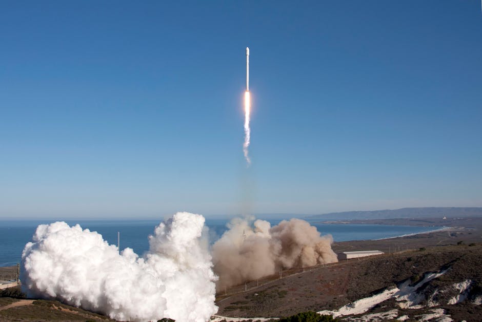 A rocket launches over the ocean, leaving behind smoke and fire trails. Scenic backdrop with clear skies.