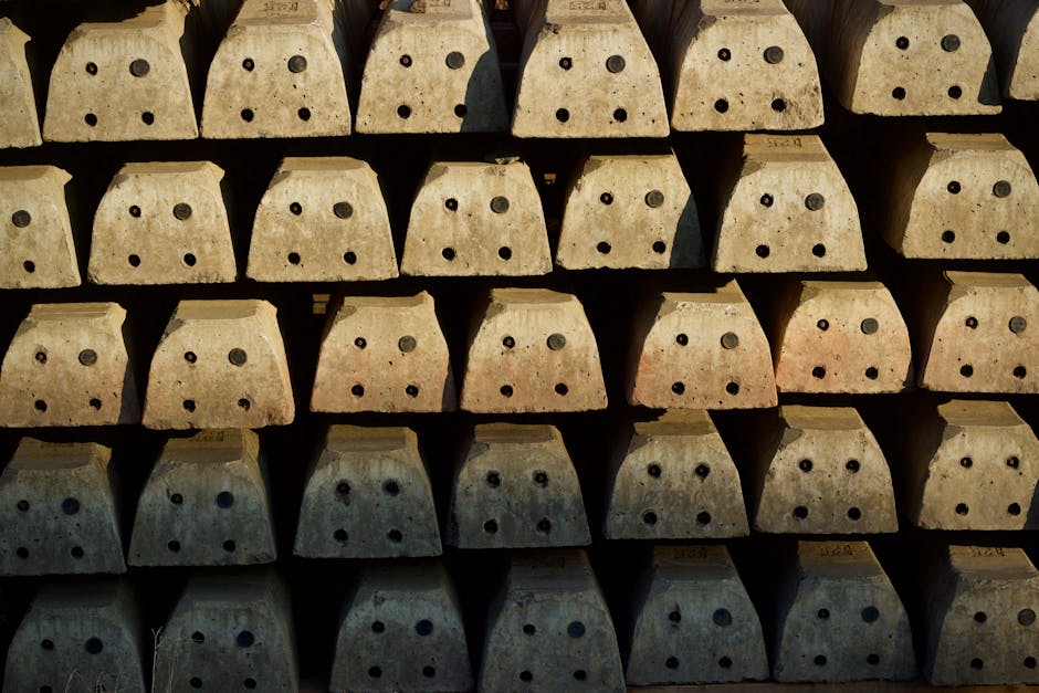 Close-up view of neatly aligned concrete blocks with circular holes, showcasing industrial symmetry.
