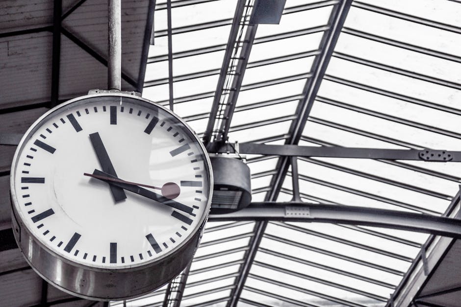 A detailed view of a large clock inside a modern railway station.