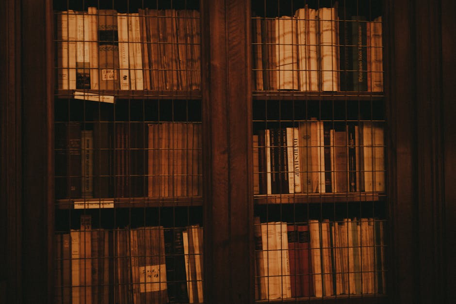 A vintage wooden bookcase filled with classic literature books, evoking a warm and nostalgic atmosphere.