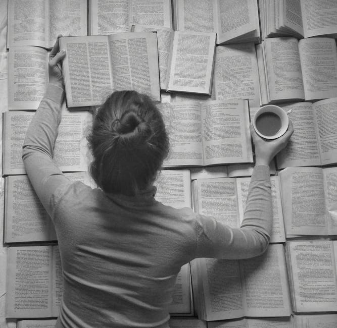 Woman surrounded by open books enjoying coffee, perfect stock photo for learning and relaxation themes.