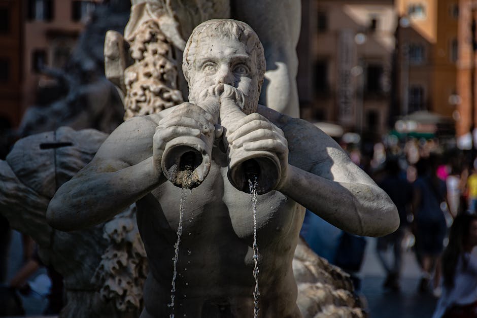 Close-up of the Triton statue spouting water at the iconic Piazza Navona fountain in Rome.