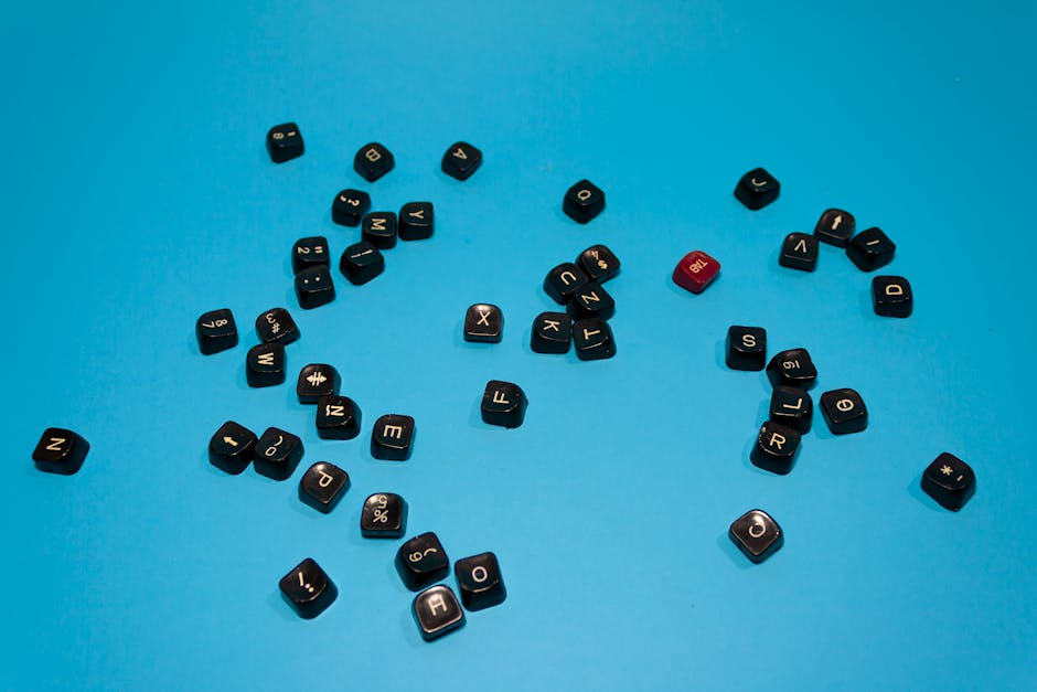 Black keyboard keys scattered on a vibrant blue surface, ideal for tech-themed designs.