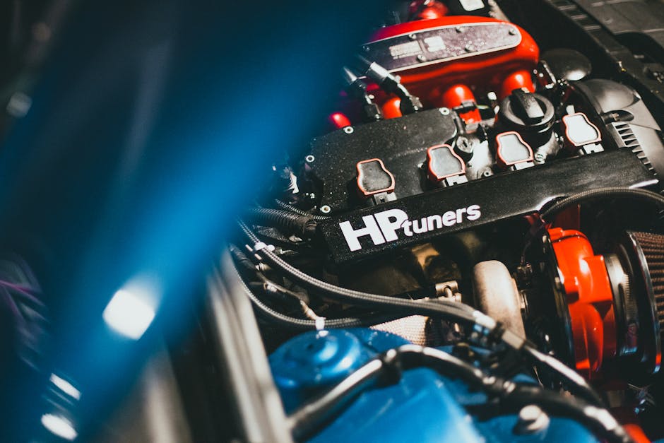 Dynamic close-up of a modern car engine featuring HP Tuners branding, showcasing automotive technology.