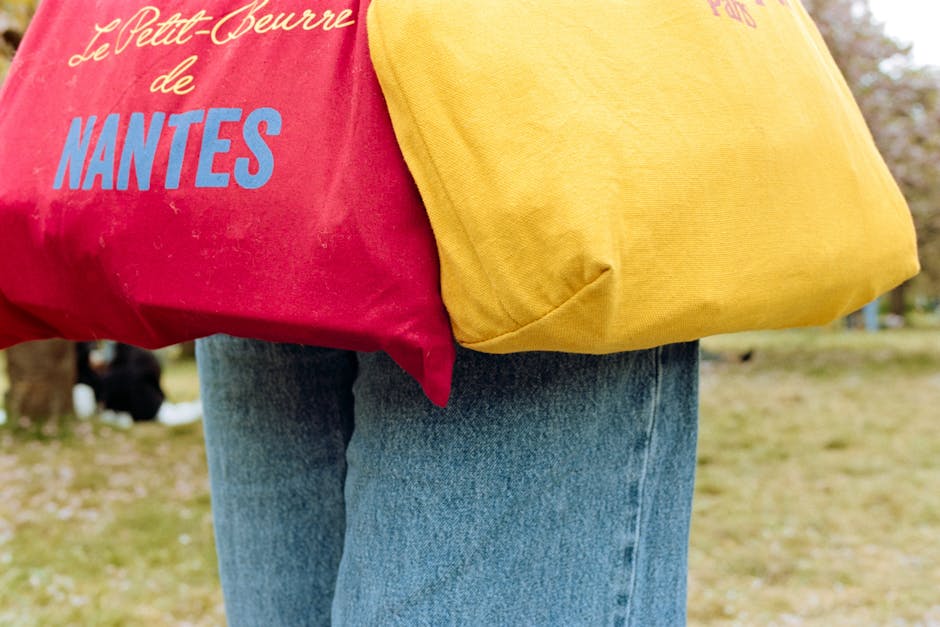 Vibrant tote bags with Nantes text in a park setting during springtime.