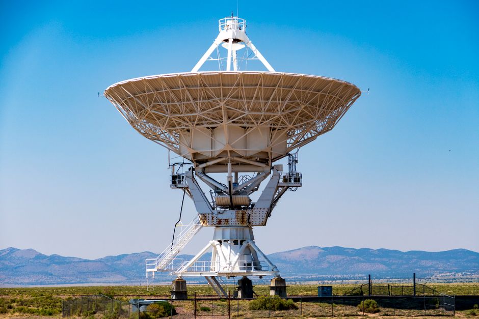Close-up of a large radio telescope at the VLA, Socorro, New Mexico, against a clear blue sky.