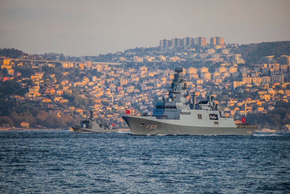 Turkish Navy warships navigate the Bosporus during a sunny day with Istanbul's skyline in the background.