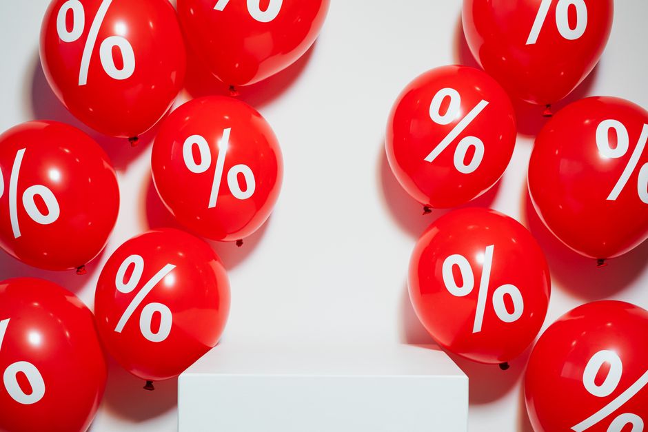 Red balloons with percentage signs, ideal for marketing promotions and sales events.